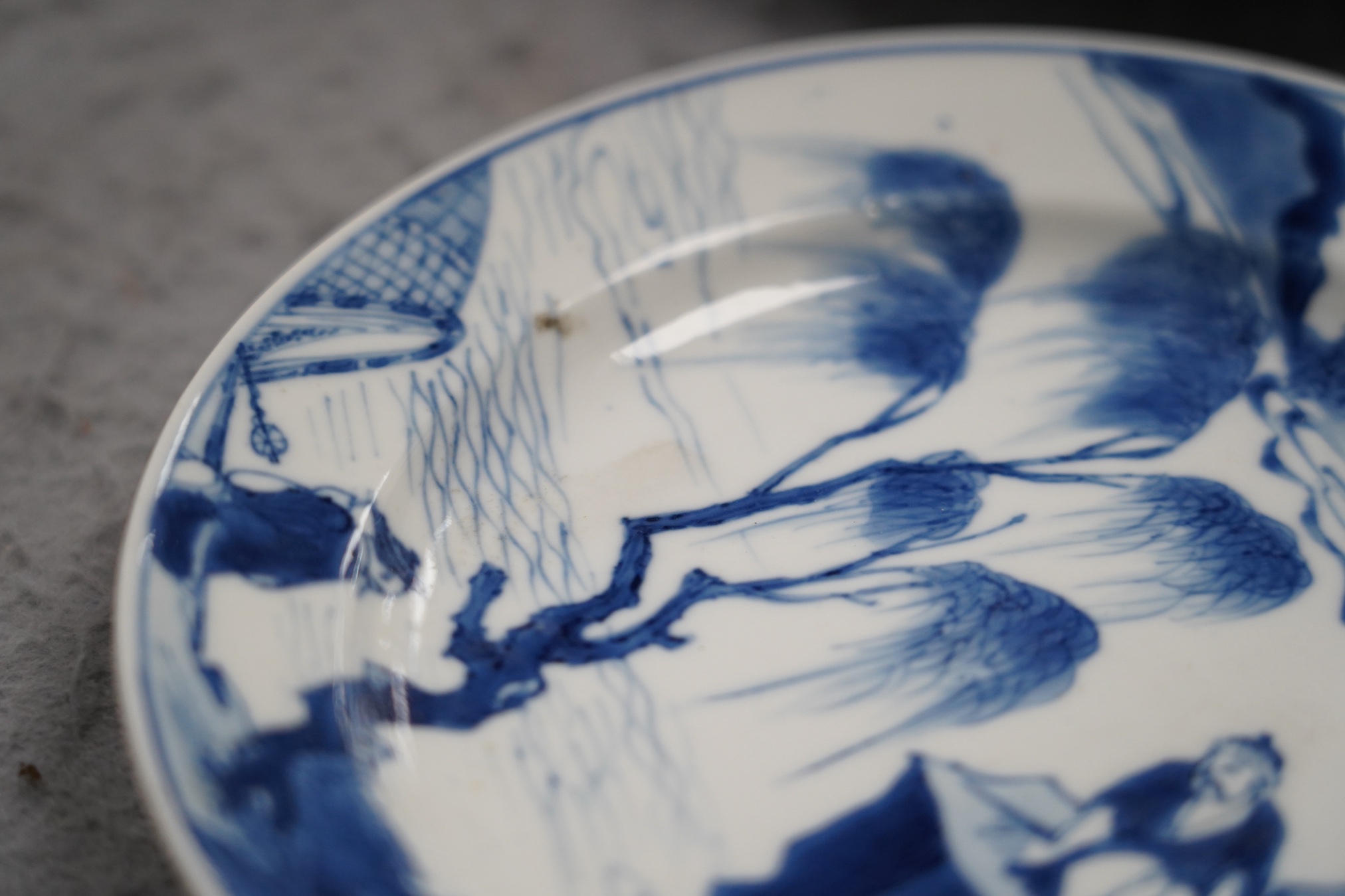 A pair of Chinese blue and white small plates, Kangxi period, hairline cracks to one plate.